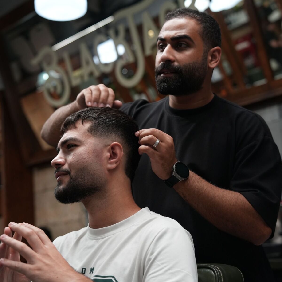 Blackjack barber styling a client’s hair