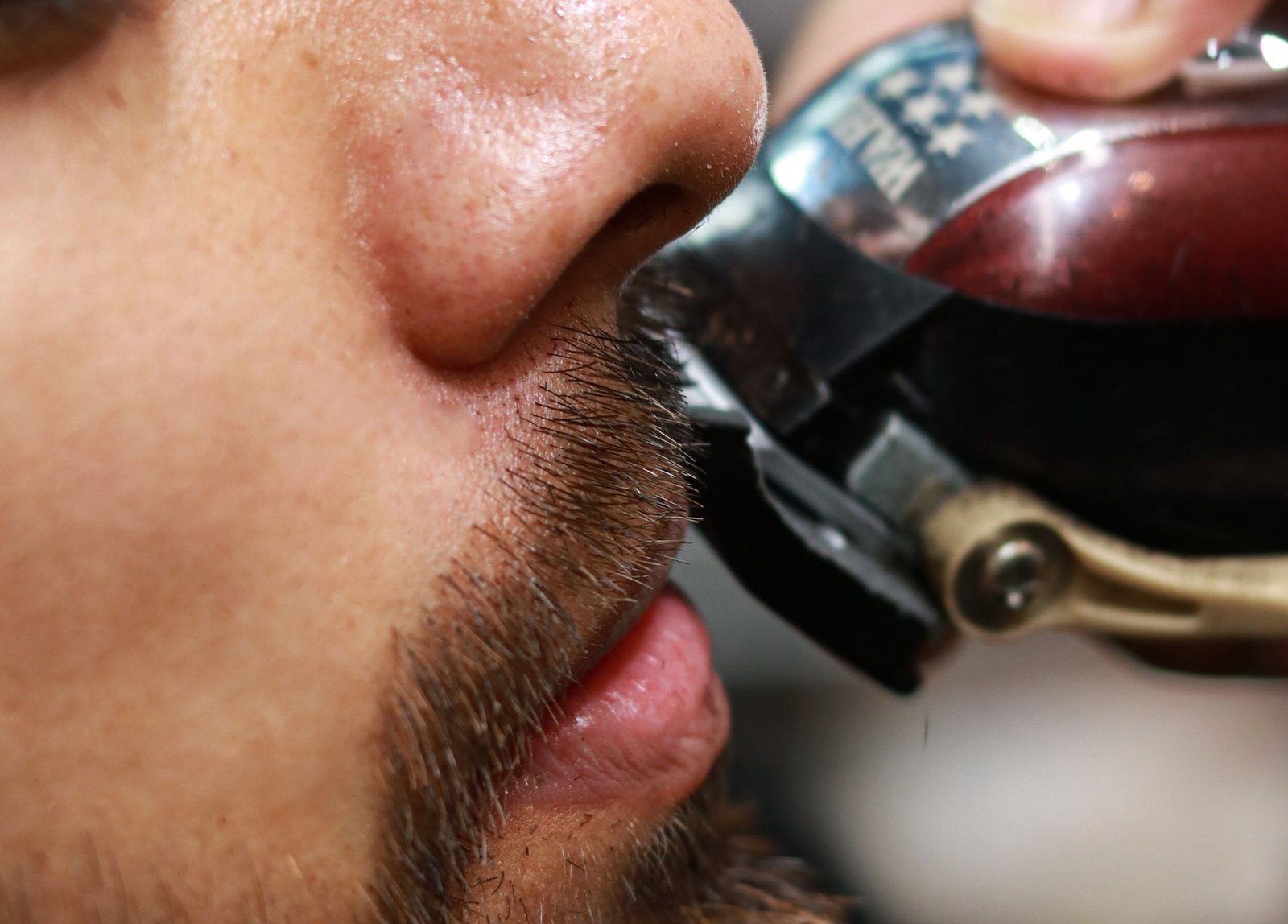 Blackjack barber detailing a client’s moustache at Bay Avenue
